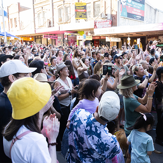 A crowd of people dancing in the street